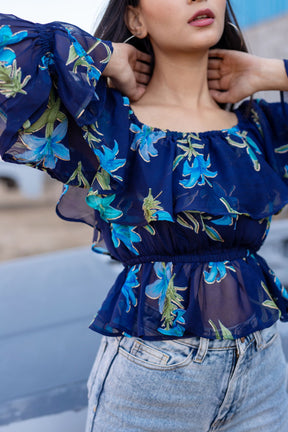 BERRY BLUE FLORAL TOP with ruffled sleeves and floral design.