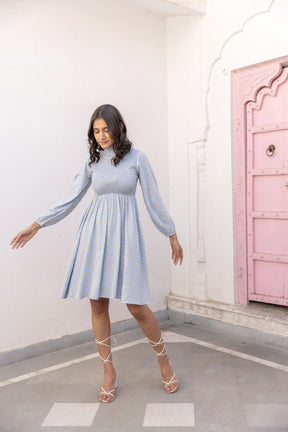 Cotton smocked midi dress in pastel blue with floral pattern.