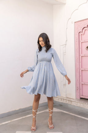 Elegant cotton smocked midi dress in light blue with floral print.