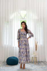 Smocked co-ord set model posing in a bright floral dress.
