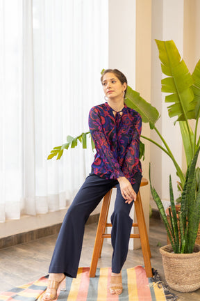 Model wearing MIDNIGHT DAWN TOP with stylish pants and accessories.