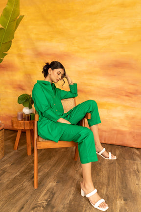 Woman in green co-ord set sitting on chair, stylish summer fashion.