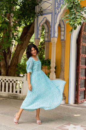 Sky blue pleated maxi dress perfect for elegant summer occasions.